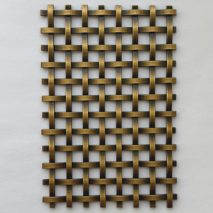 Brass-colored metal lattice with interwoven strips forming a grid pattern, photographed close-up.